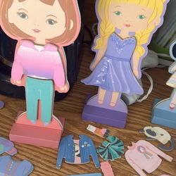 Six cardboard dress up dolls with magnetized accessories
