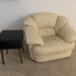 A beige armchair and a side table