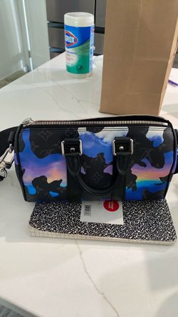 This Louis Vuitton Sunset Monogram Eclipse Keepall Bandouliere 25