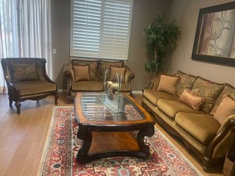 Formal couches, loveseat, table, rug, and picture