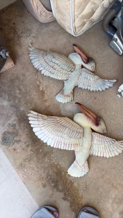 Two 26 x15 pellicans metal wall hangings