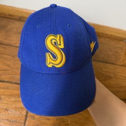 A royal blue Seattle Mariners baseball cap featuring a yellow throwback 'S' logo, often categorized as a Cooperstown Collection item Smoke free home  
