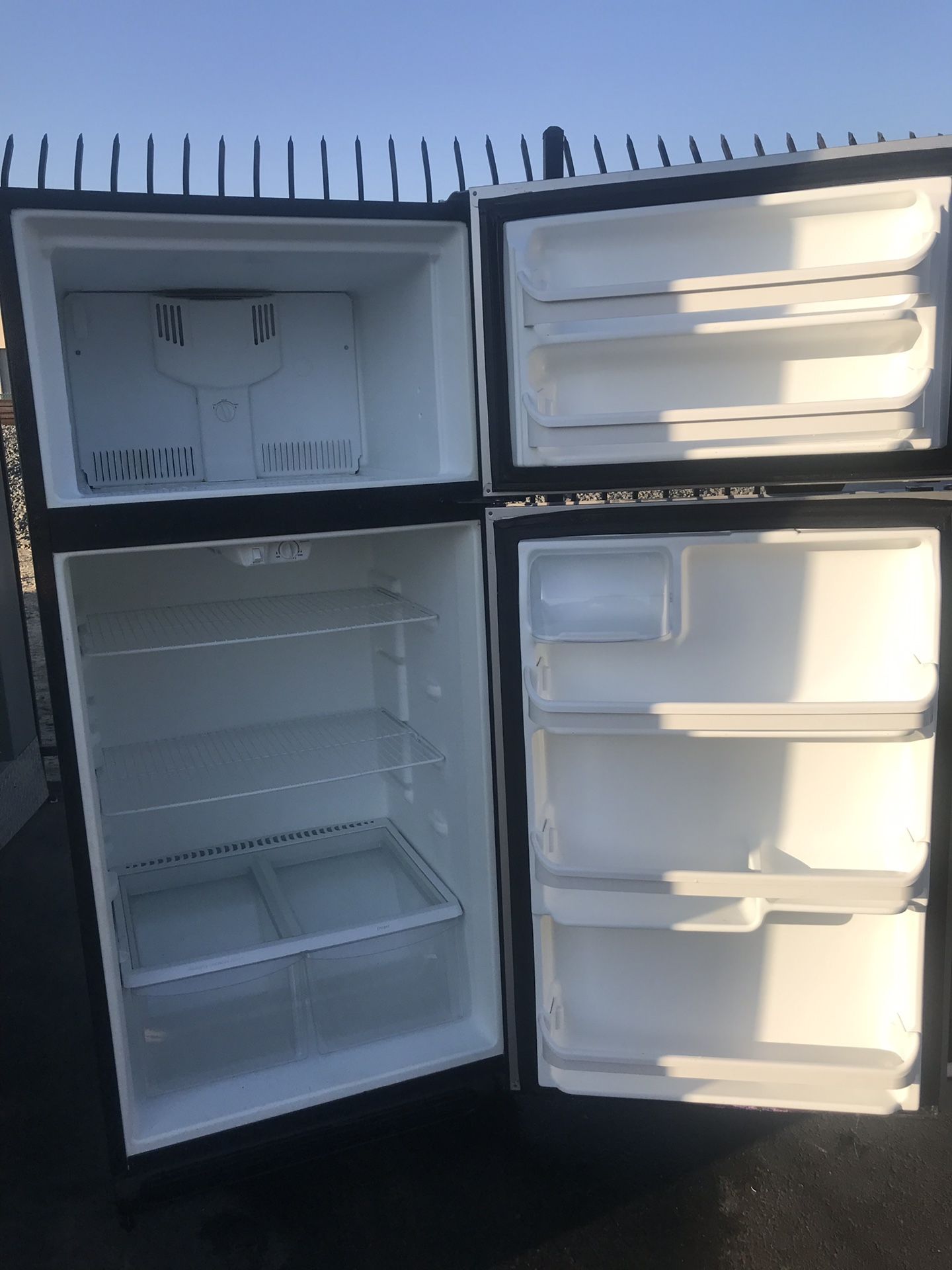 Stainless steel and black apartment full size Frigidaire refrigerator