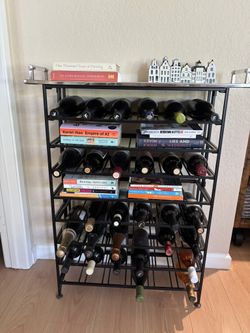 Wine Rack - foldable, no assembly, holds 54 bottles (full price is $139). Mirror tray not included.