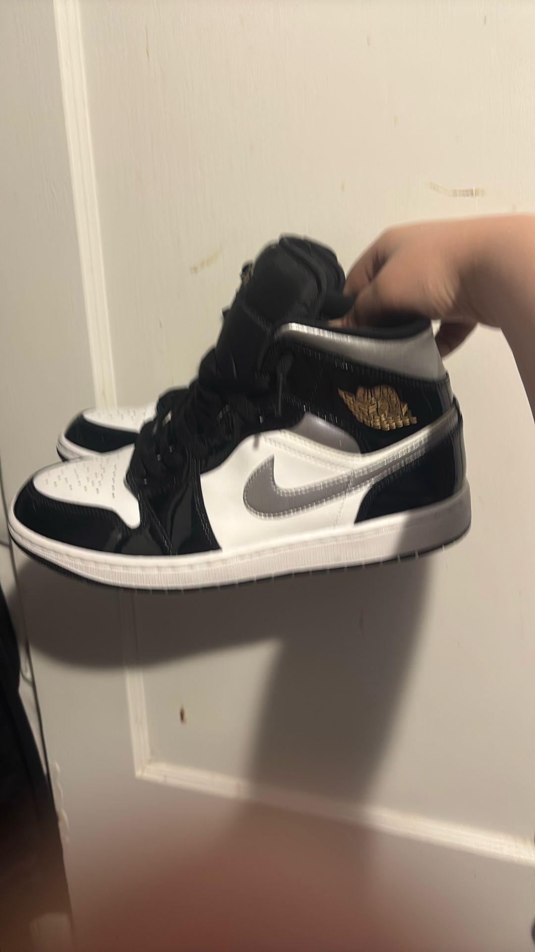 Nike Air Jordan 1 Mid SE in a Black/Metallic Silver-White colorway. Jordan 1