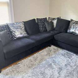Black sectional with decorative pillows 