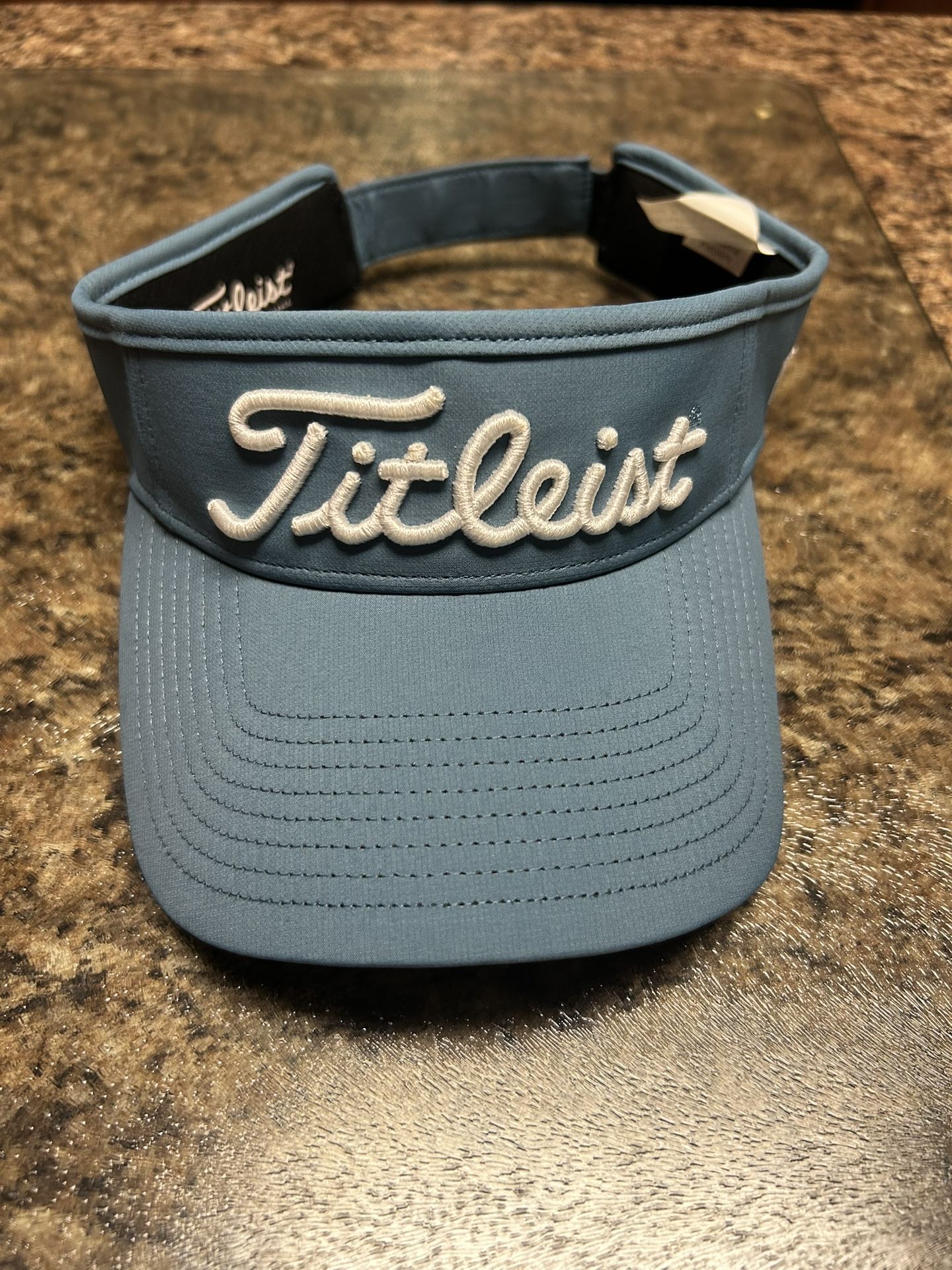 Blue Titleist golf visor in excellent condition.  Like New!
