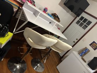 white table with two adjustable barstool chairs