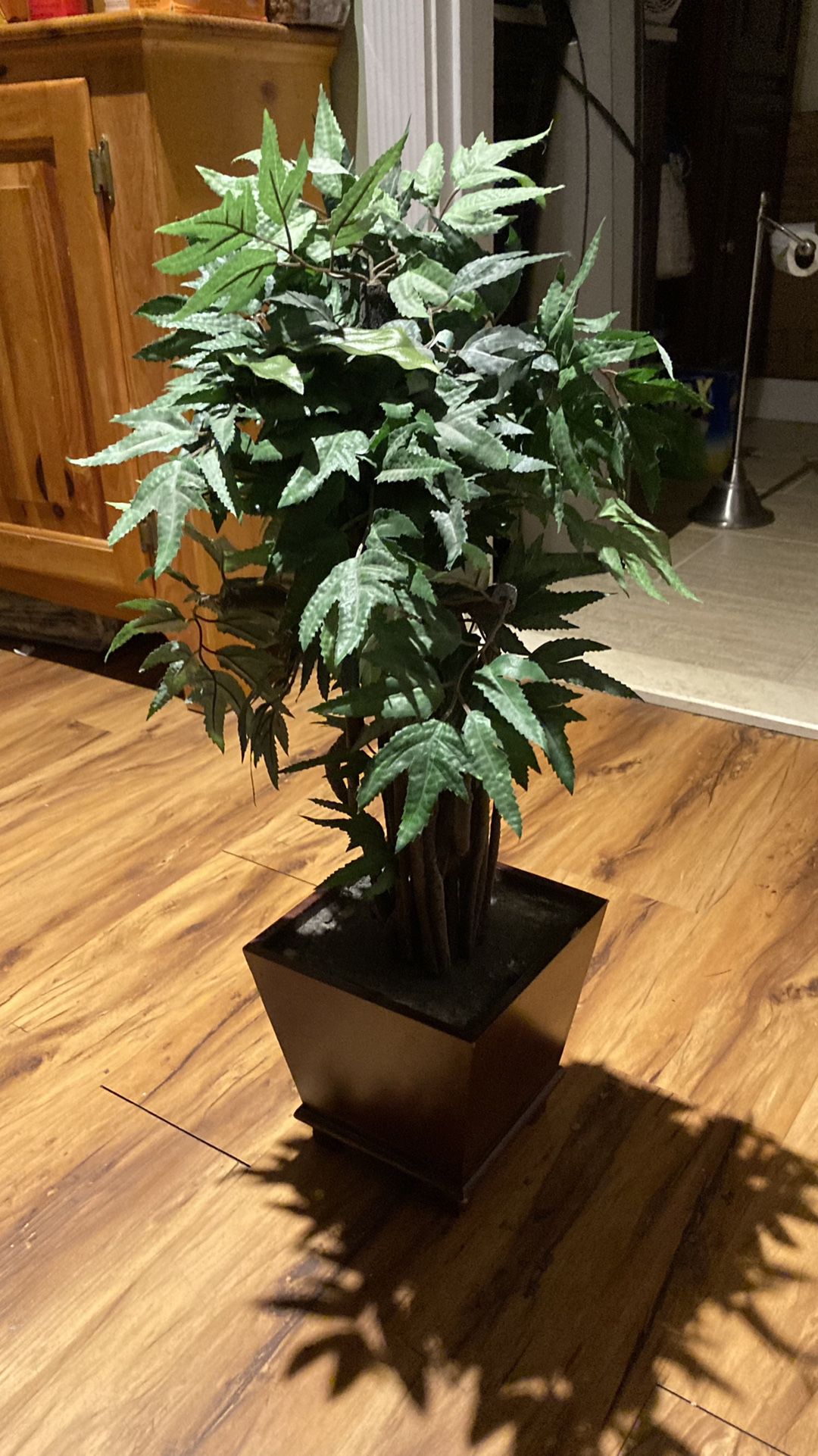Fake plant wooden base About 24 inches tall and about 10 inches wide from a cleaning smoke free