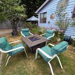 Fire table with four matching chairs and cushions Fire pit with four matching chairs and cushions