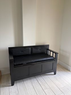 Black entryway storage bench with cushioned seat and back