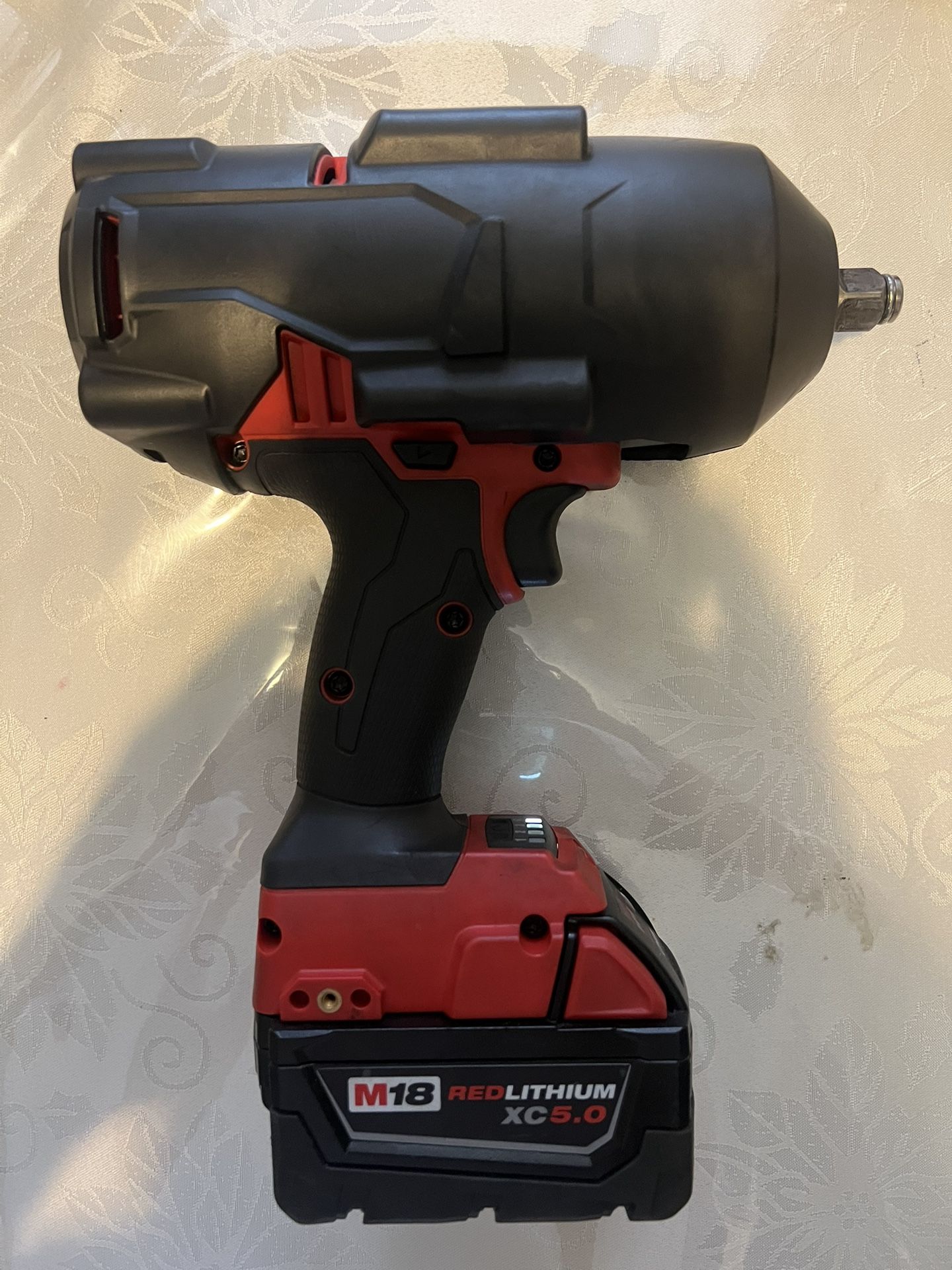 Milwaukee M18High Torque Impact Wrench, With The .5 Battery, And The Boot Cover Protection.