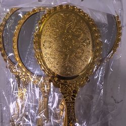 Beautiful golden handheld mirror