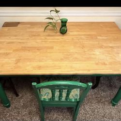 Dining table with three chairs and stain