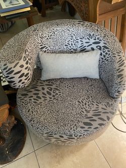 A vintage swivel barrel chair.