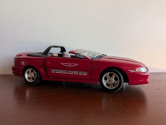 1/18 scale diecast model of a 1994 Ford Mustang, specifically a Ford Mustang GT Coupe. 