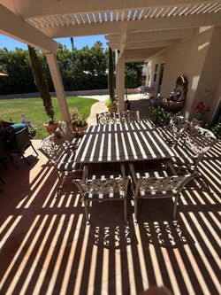 Large patio table with 8 armed chairs