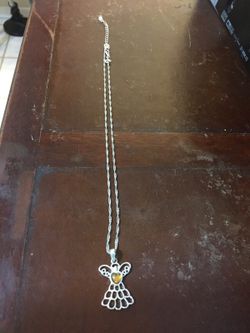 Angel with amber colored gem necklace