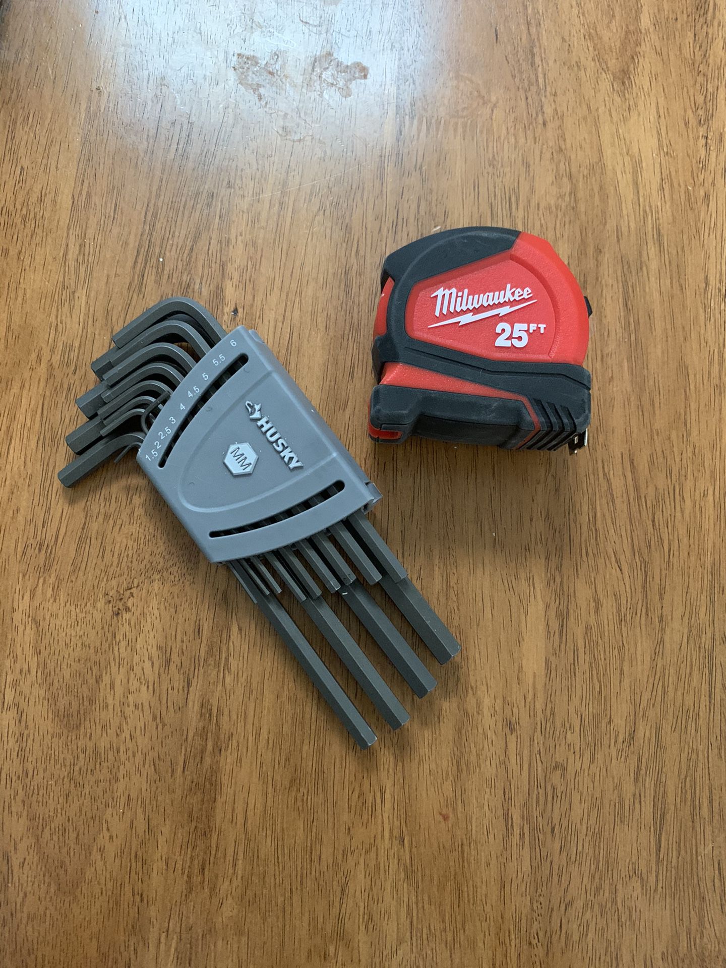 Multiple Allen wrenches and 25 ft measuring tape