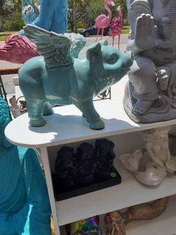 Cool blue flying pig statue