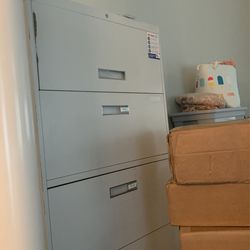 Four drawer gray file cabinet in working order