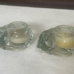 Pair of clear molded glass sleeping cat votive candle holders.