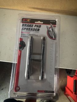 Brake pad spreader