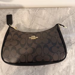 Coach brown wristlet with gold hardware