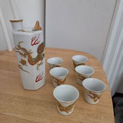 Vintage Japanese Dragonware sake set. One decanter bottle, six and a half inches tall, two and a half inches diameter, plus six cups, one and a half i