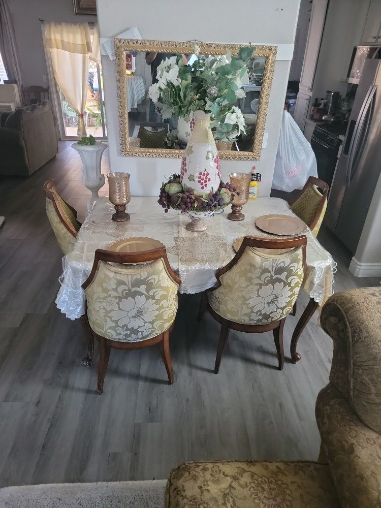 A eating table  With 6 Chairs And Without all the things on top of the table