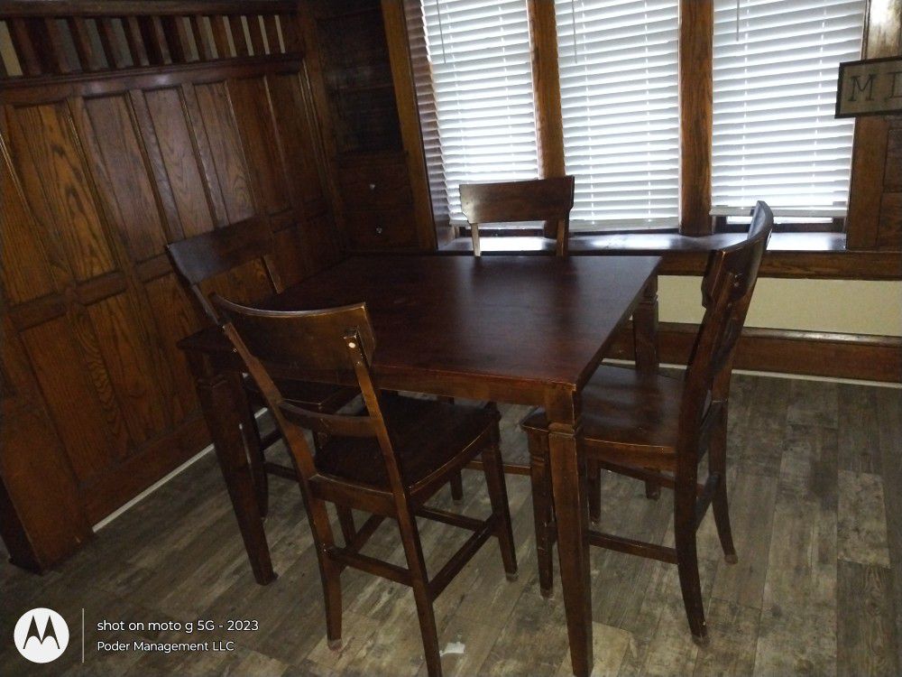 Tall mahogany colored table and chairs