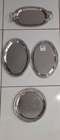 Price $10-$20 each Set of 4 vintage silver‑plated serving trays. One 14"x7" grape‑handle oval tray, two 12"x8" oval trays, one 10" round tray. Decorat