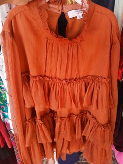 Size Small womens ruffle blouse in a rust orange color