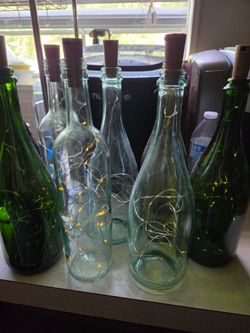 7 bottles with fairy lights.  a few need new batteries