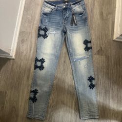 Amiri Light Wash Distressed Jeans with Patches
