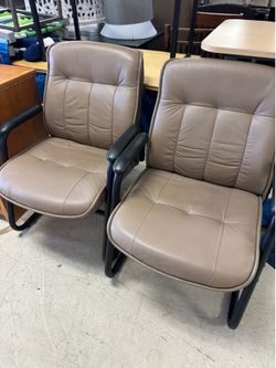 bonded leather  chairs featuring a sled base and padded arms