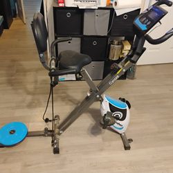 Exercise bike with spin disc and tension straps