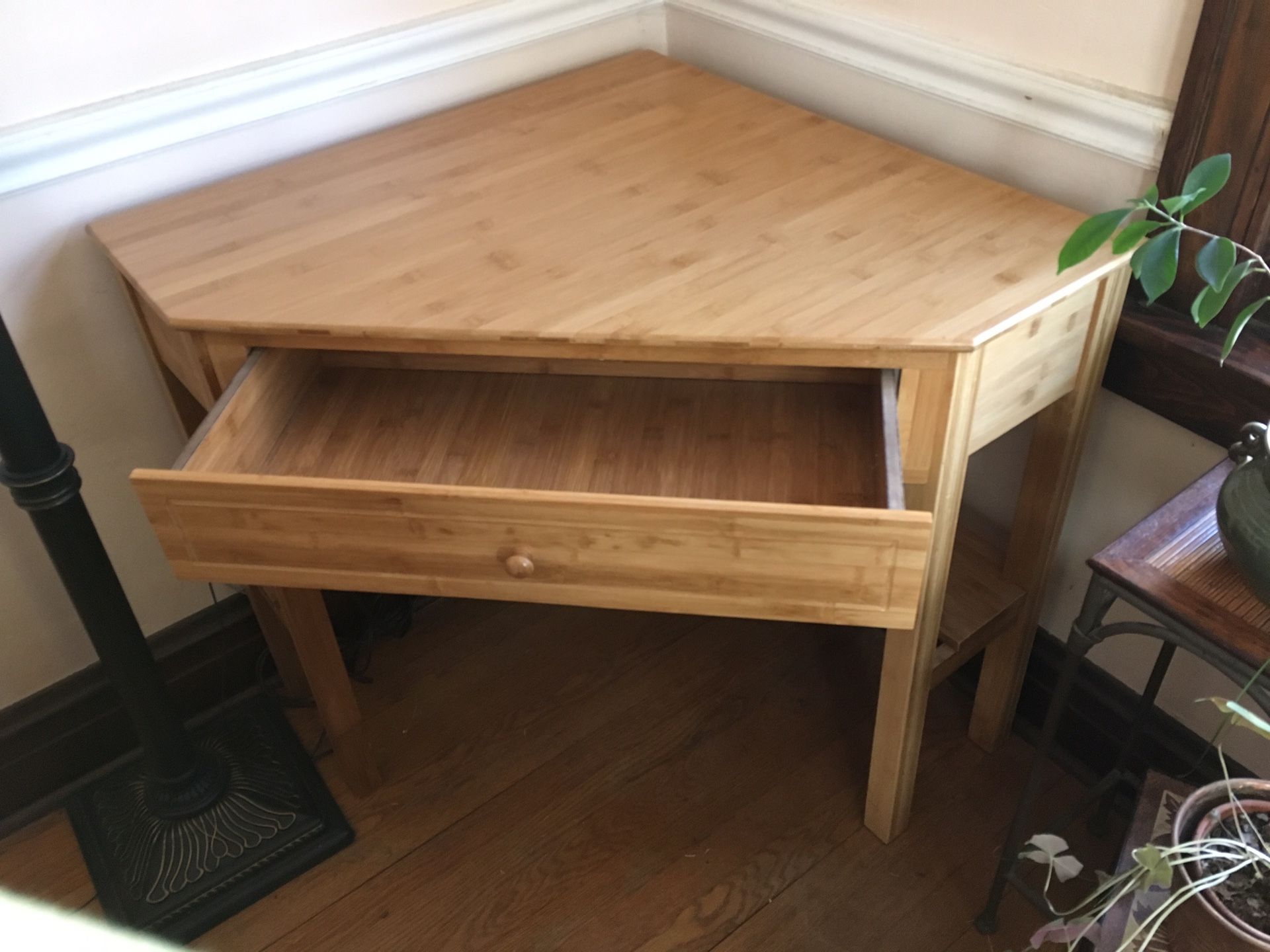 Solid wood corner desk. Has one drawer and a shelf underneath that goes around the desk.