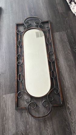 Elegant wall mirror with ornate metal frameuuu. 53-1/2” x 20”. Heavy.