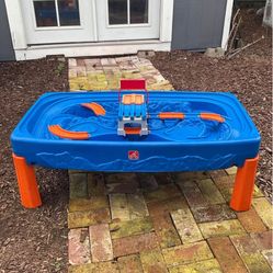 Step2 Hot Wheels Car & Track Play Table  The table features molded-in tracks and non-removable bridges to help keep accessories in one place.  It prov