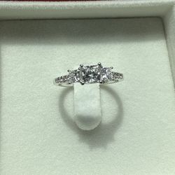 Engagement Ring Description Style: Princess Cut  Design: Past, Present, and Future  Material: 14 Karat Gold  Details: This exquisite engagement ring f