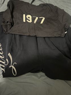 Fear of God Essentials shirt and baggy caligraphy sweatpants