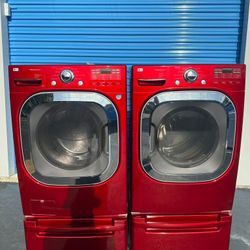 LG front-loading washer and dryer set with extra-capacity red pedestal