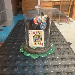 Casino Chips Under Glass On A Hand With some Stones 