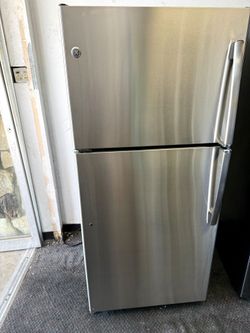 GE stainless steel apartment size refrigerator and top freezer