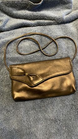 Small black leather purse with bow design.