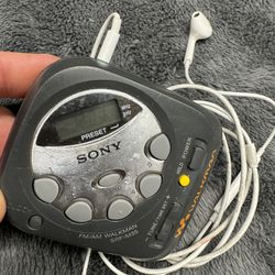 Vintage Compact Sony Am/FM Walkman with Apple Earpods w/Mic. Works great!  Runs on Two AAA.  