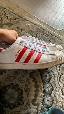 Red and white Addias super stars