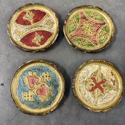 set of Florentine wooden coasters. These coasters are characterized by their handcarved and hand-painted designs,