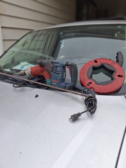 Milwaukee electric drill & bosh rotary hammer drill with a couple of drill bits.  Electric.  100 feet steel tape.